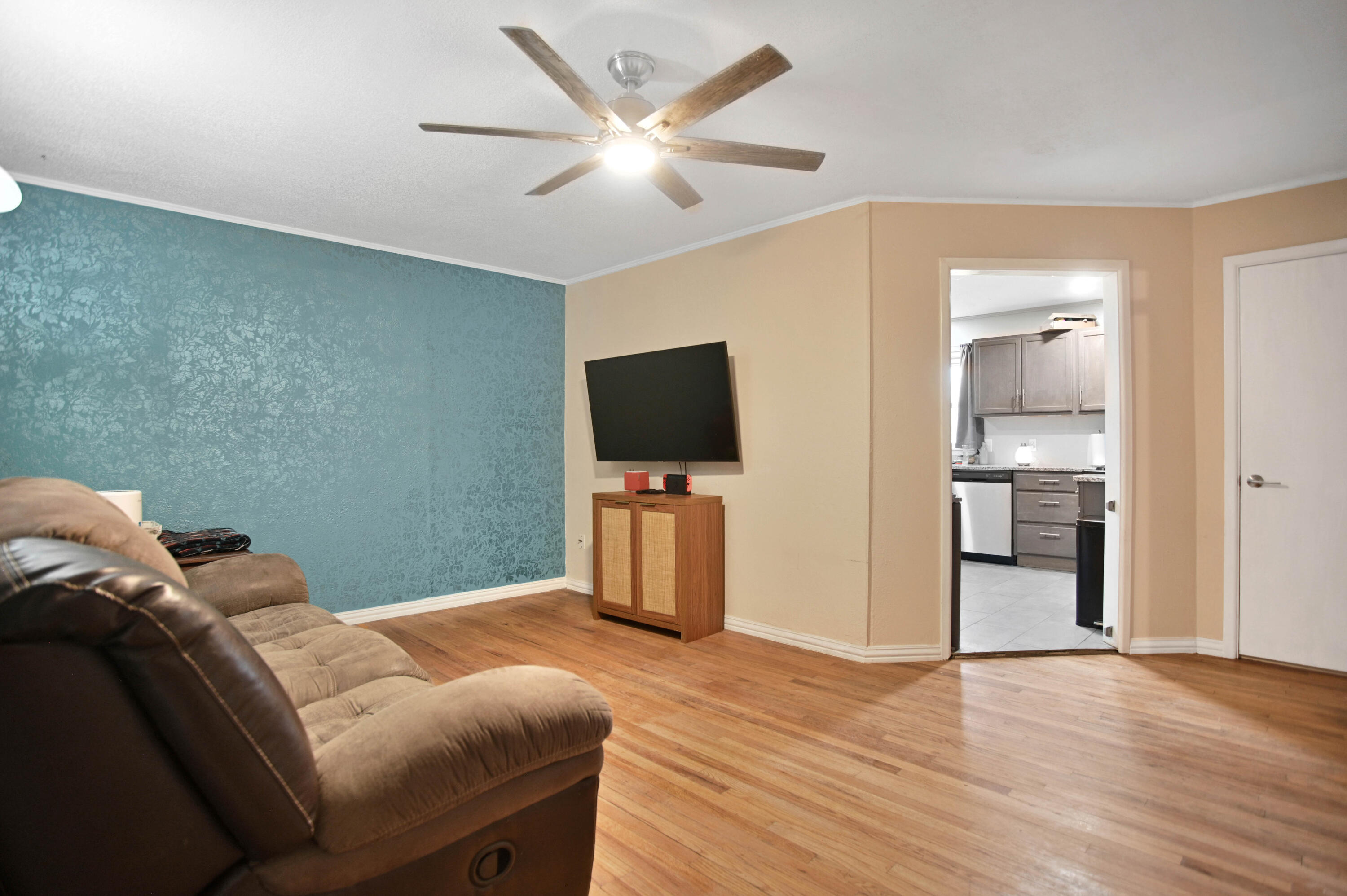 704 4th Street Smyer, TX 79367 - Photo 4 of 38 a bedroom with a bed and a flat screen tv