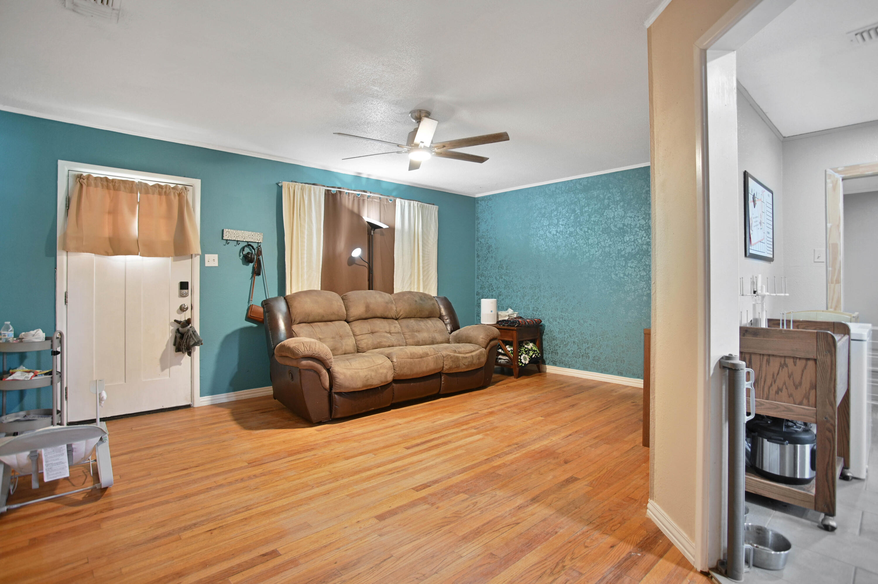 704 4th Street Smyer, TX 79367 - Photo 5 of 38 a bedroom with a bed and a chandelier