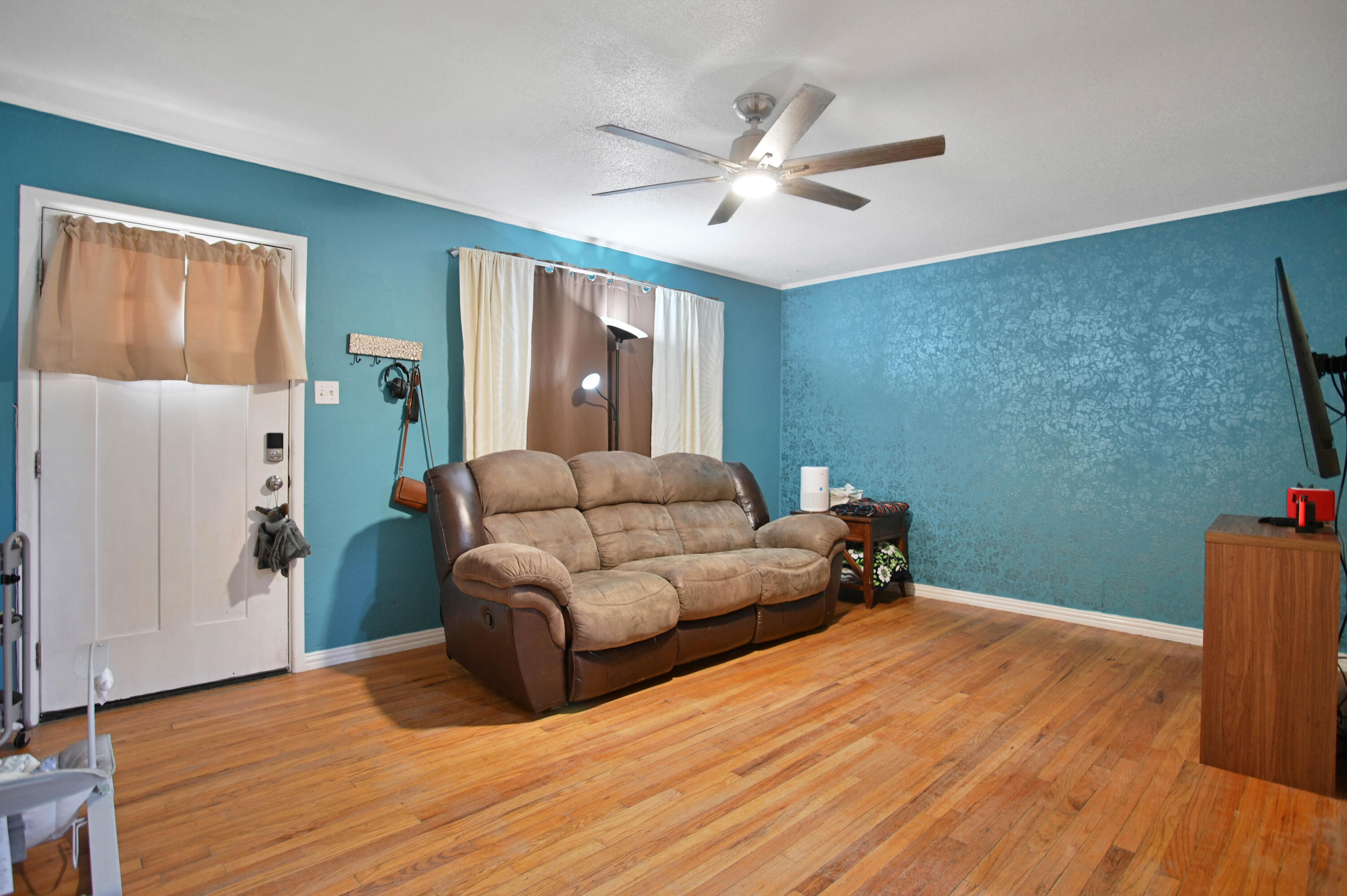704 4th Street Smyer, TX 79367 - Photo 6 of 38 a living room with furniture and a wooden floor