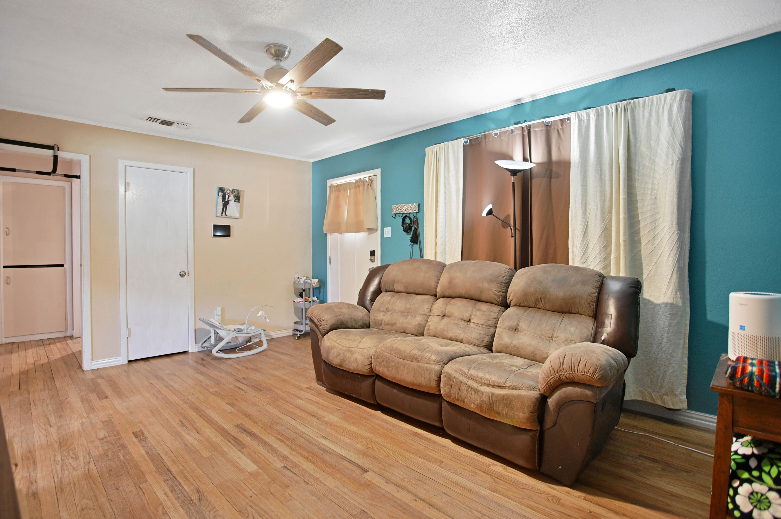704 4th Street Smyer, TX 79367 - Photo 7 of 38 a living room with furniture and a large window with wooden floor