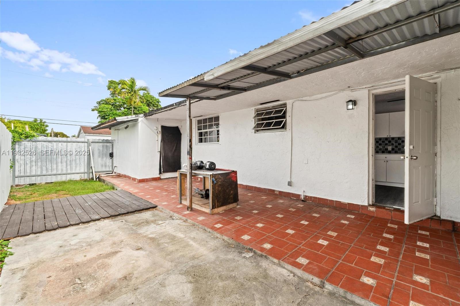 11441 Southwest 2nd Street, Unit 11443 Sweetwater, FL 33174 - Photo 11 of 31 a backyard of a house with table and chairs