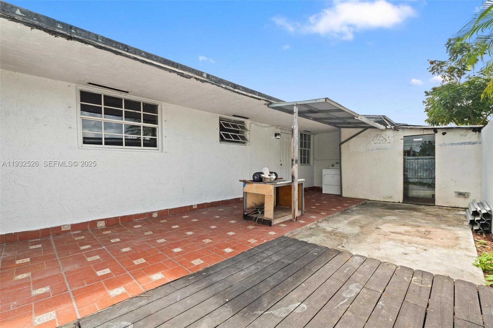 11441 Southwest 2nd Street, Unit 11443 Sweetwater, FL 33174 - Photo 13 of 31 a backyard of a house with table and chairs
