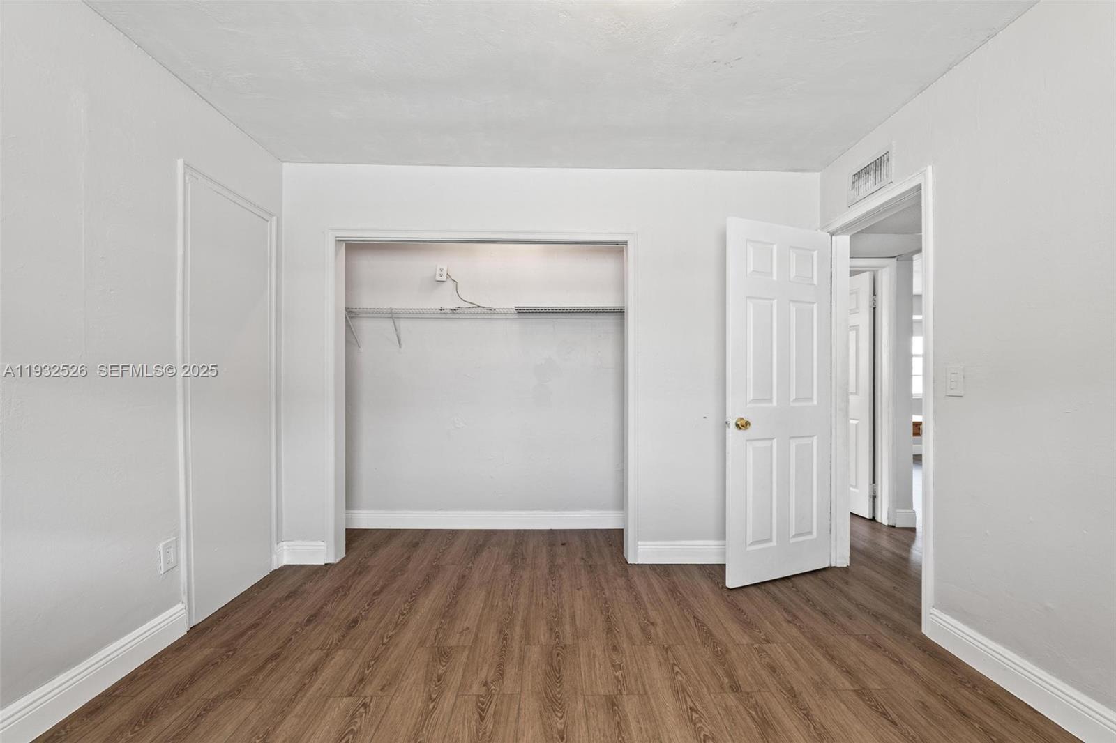 11441 Southwest 2nd Street, Unit 11443 Sweetwater, FL 33174 - Photo 16 of 31 a view of an empty room with wooden floor