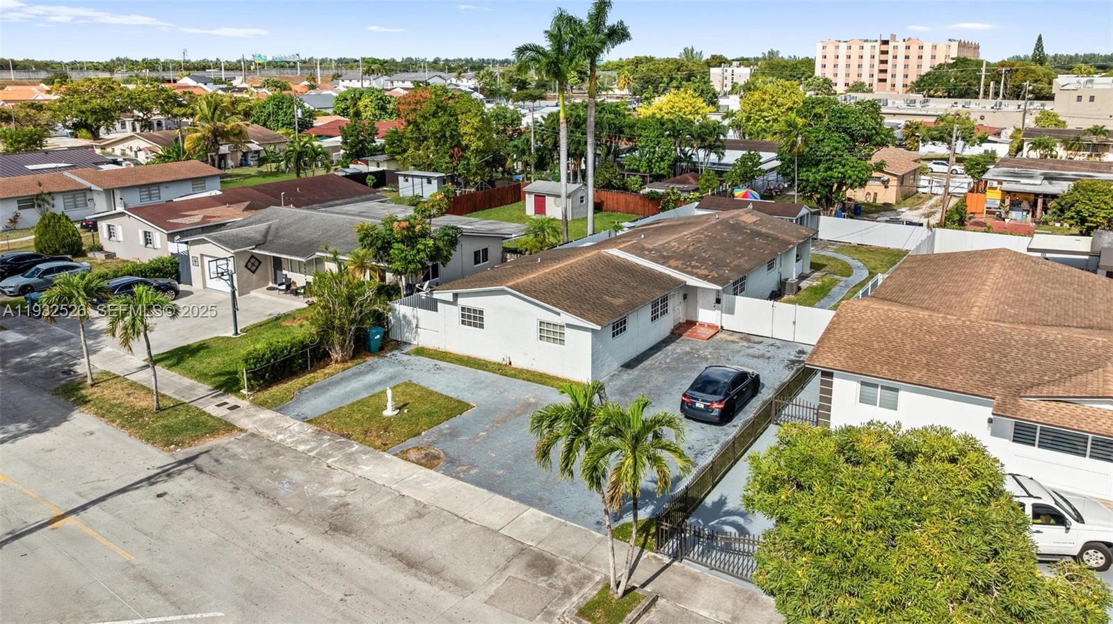 11441 Southwest 2nd Street, Unit 11443 Sweetwater, FL 33174 - Photo 22 of 31 an aerial view of a house with a garden and lake view