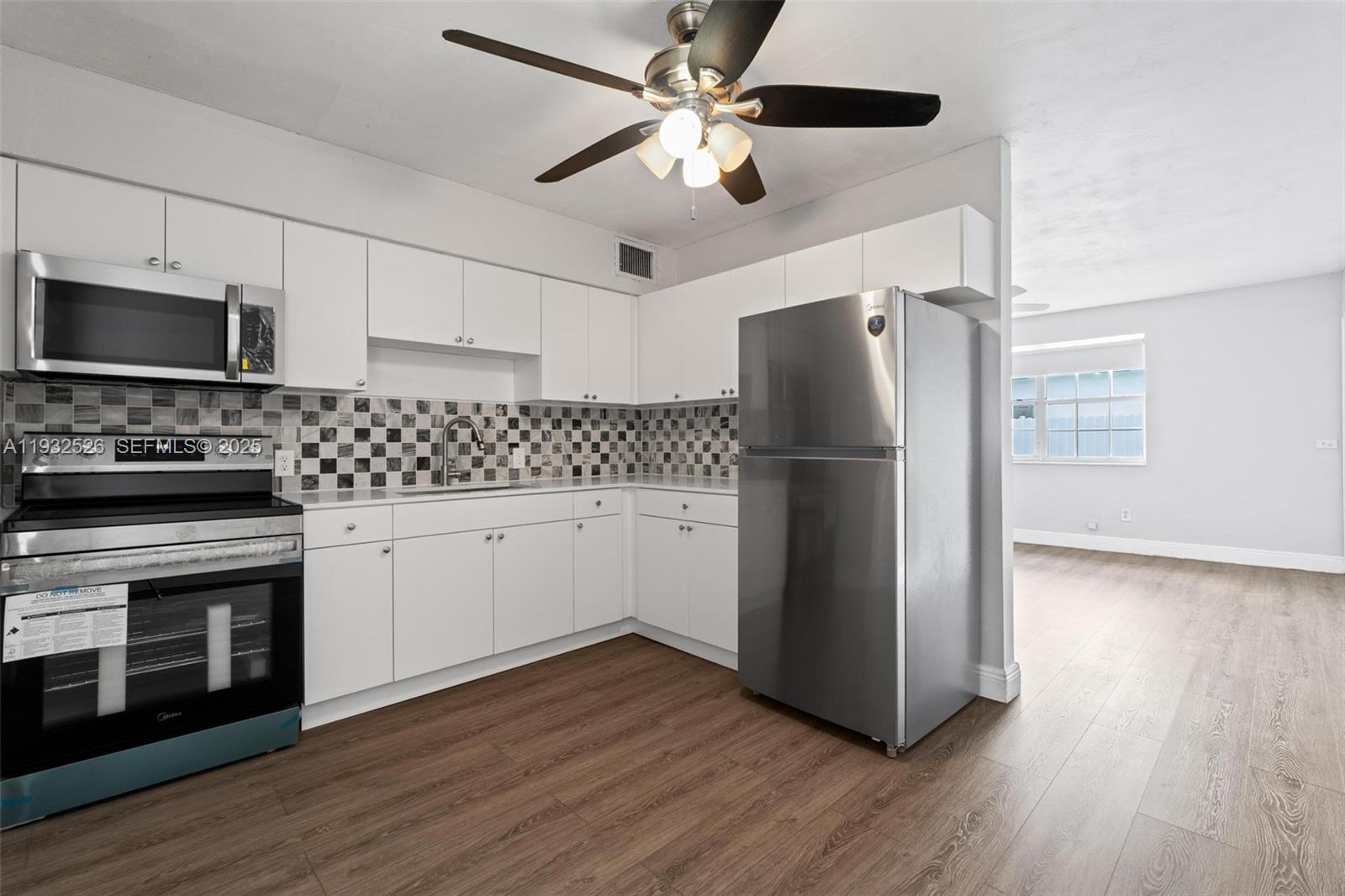 11441 Southwest 2nd Street, Unit 11443 Sweetwater, FL 33174 - Photo 9 of 31 a kitchen with a refrigerator stove and microwave