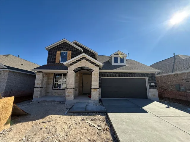 a front view of a house with parking area