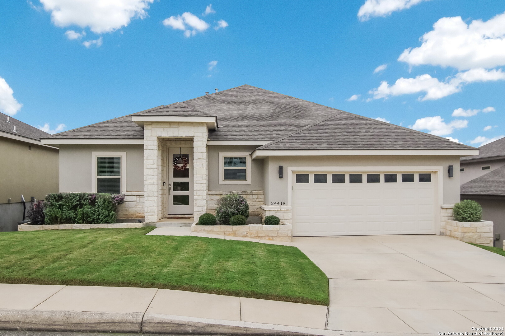 24419 Canyon Row San Antonio, TX 78260 - Photo 1 of 1 a front view of a house with a yard and garage