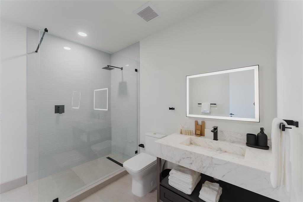 2750 Griffin Road, Unit 309 Fort Lauderdale, FL 33312 - Photo 26 of 47 a bathroom with a granite countertop sink a toilet a mirror and shower