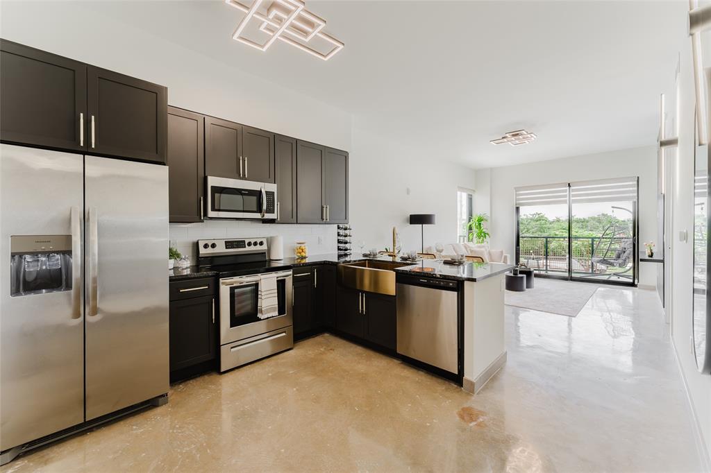 2750 Griffin Road, Unit 309 Fort Lauderdale, FL 33312 - Photo 5 of 47 a large kitchen with a large window and stainless steel appliances