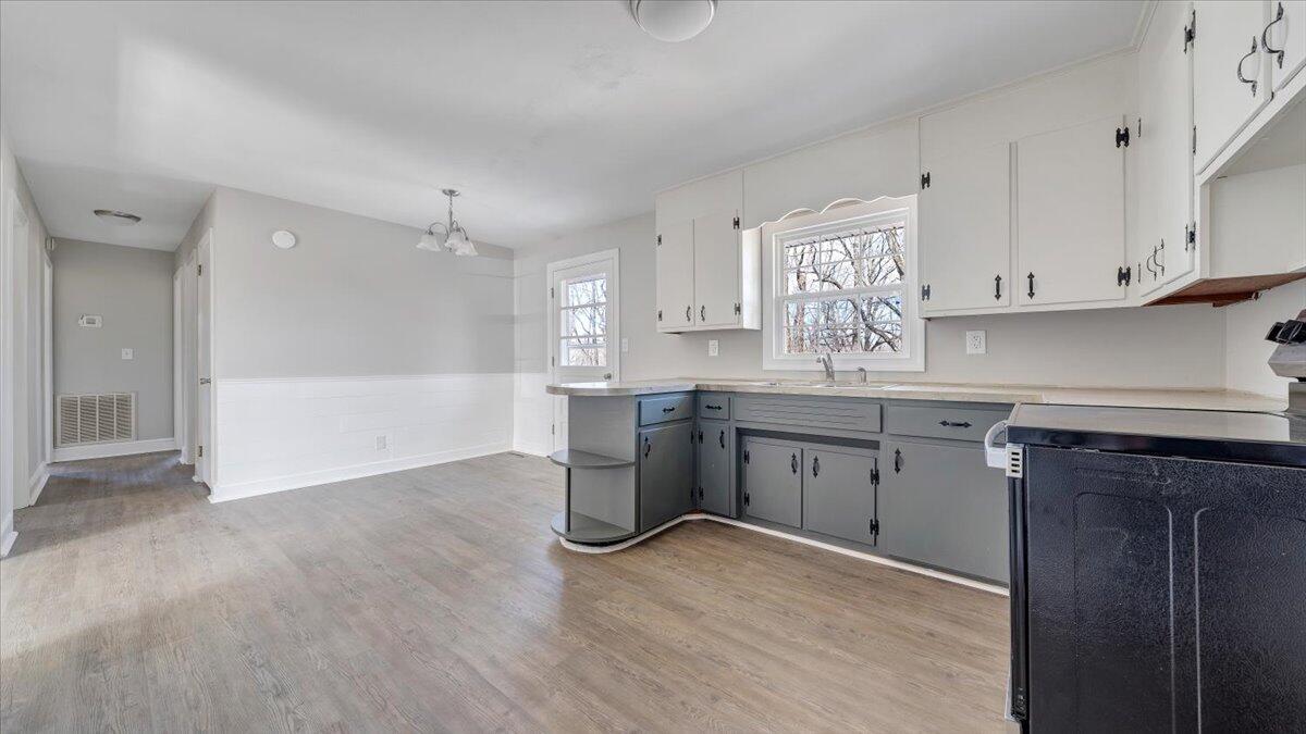 200 Cornell Road Rocky Mount, VA 24151 - Photo 13 of 44 a kitchen with stainless steel appliances granite countertop a sink cabinets and wooden floor