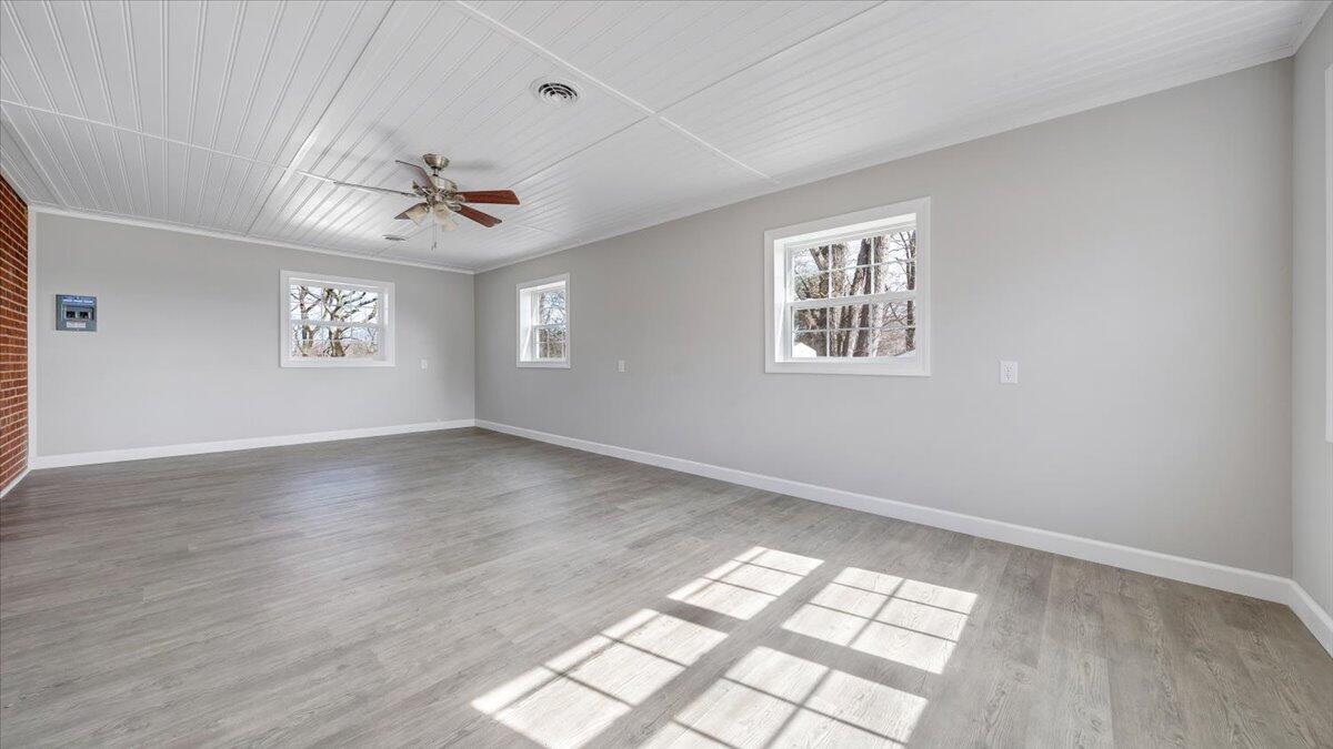 200 Cornell Road Rocky Mount, VA 24151 - Photo 22 of 44 a view of an empty room with a window and wooden floor