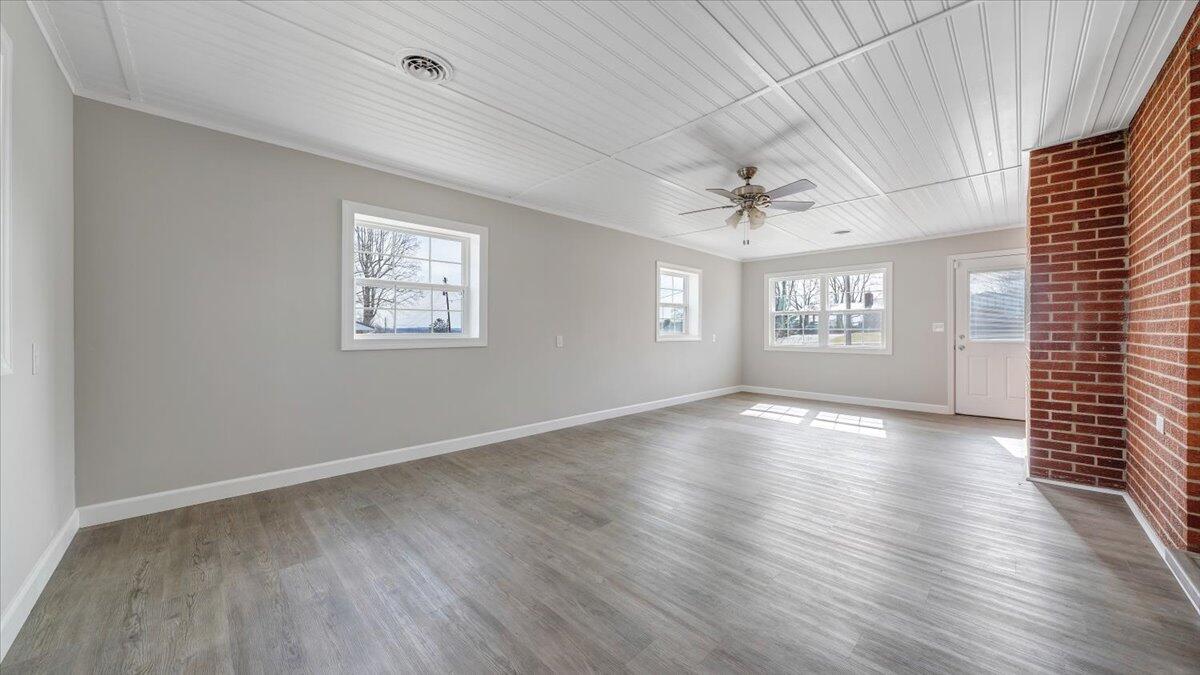 200 Cornell Road Rocky Mount, VA 24151 - Photo 27 of 44 an empty room with wooden floor chandelier and windows