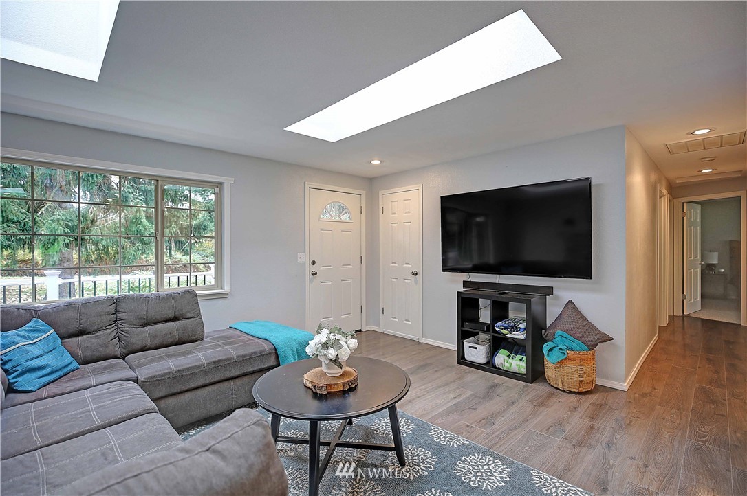 4415 212th Street Southeast Bothell, WA 98021 - Photo 4 of 29 a living room with furniture and a flat screen tv