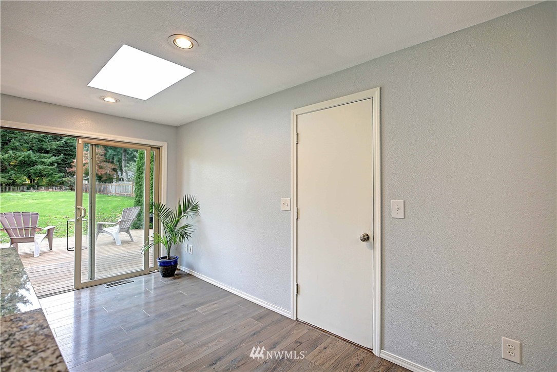 4415 212th Street Southeast Bothell, WA 98021 - Photo 8 of 29 an empty room with wooden floor and windows