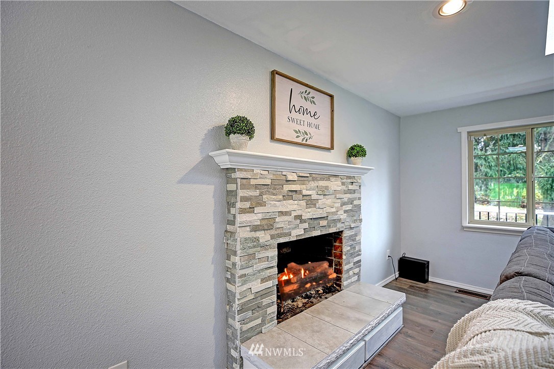 4415 212th Street Southeast Bothell, WA 98021 - Photo 9 of 29 a living room with furniture and a fireplace