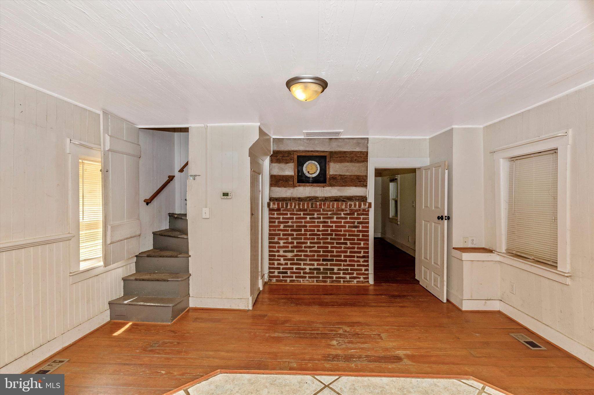 6300 Old Bohn Road Mount Airy, MD 21771 - Photo 23 of 45 a view of an empty room with wooden floor and stairs