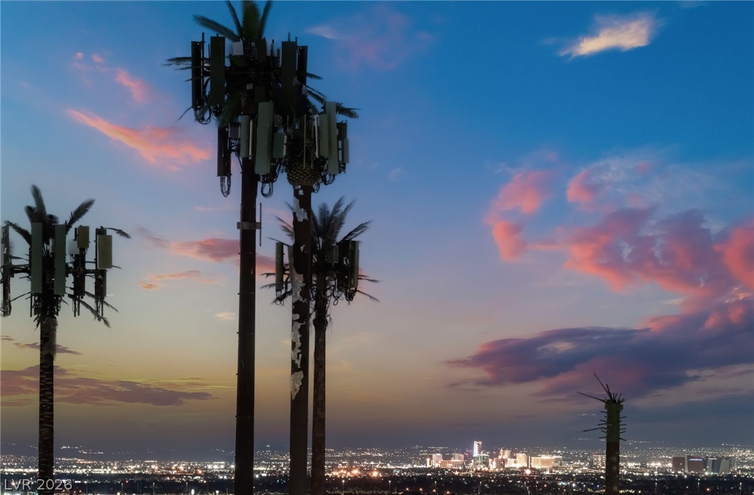6432 Spring Jog Street Las Vegas, NV 89166 - Photo 57 of 61 Witness an expansive cityscape illuminated against a dramatic twilight sky.