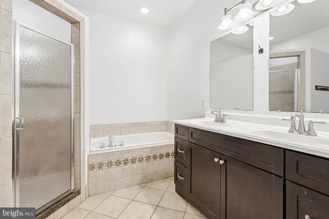 a bathroom with a double vanity sink mirror and shower