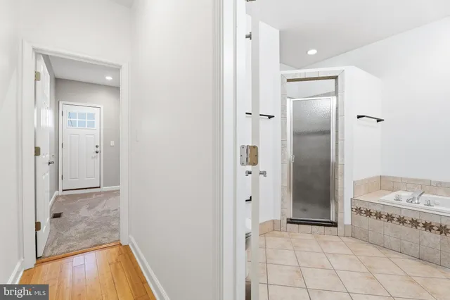 a bathroom with a tub shower and sink