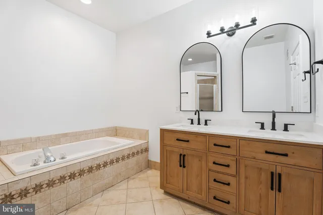 a bathroom with a double vanity sink and mirror