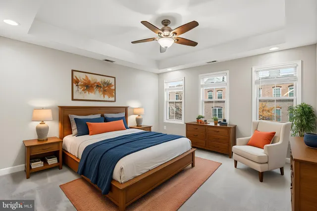 a bedroom with a bed couch and window