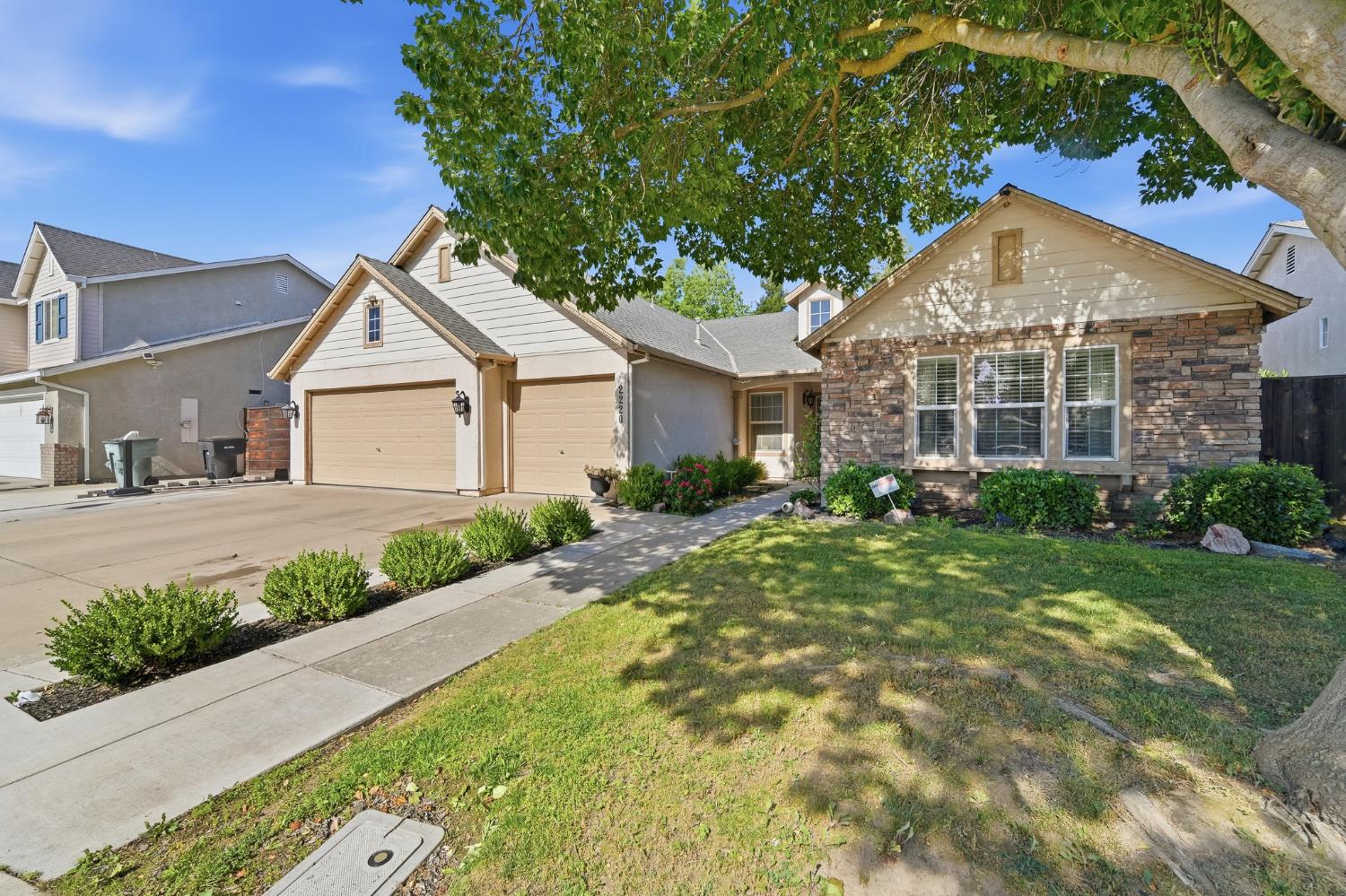 2220 Ellison Drive Modesto, CA 95355 - Photo 3 of 53 a view of a house next to a yard with plants and large trees