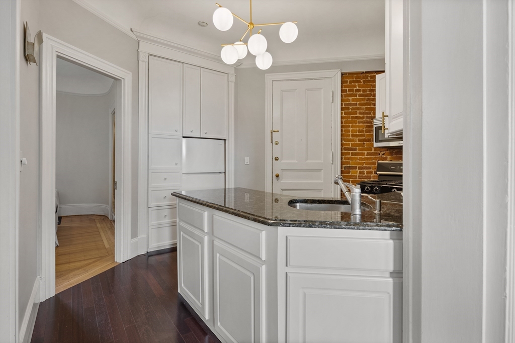 362 Commonwealth Avenue, Unit 4A Boston, MA 02115 - Photo 12 of 23 a bathroom with a granite countertop sink and a mirror