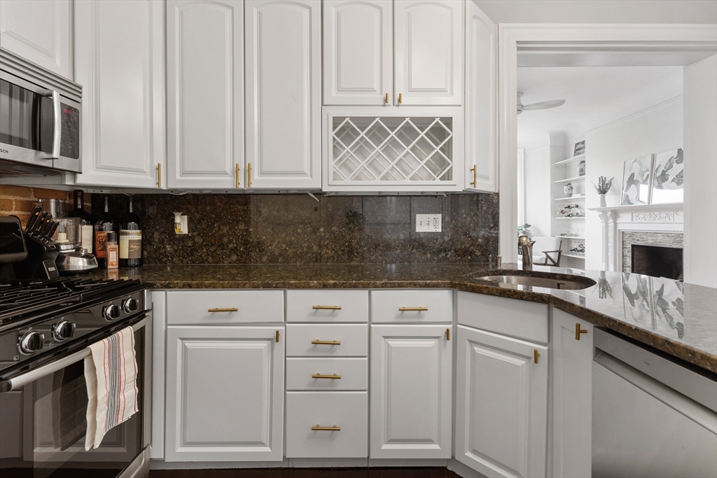 362 Commonwealth Avenue, Unit 4A Boston, MA 02115 - Photo 14 of 23 a kitchen with white cabinets and sink