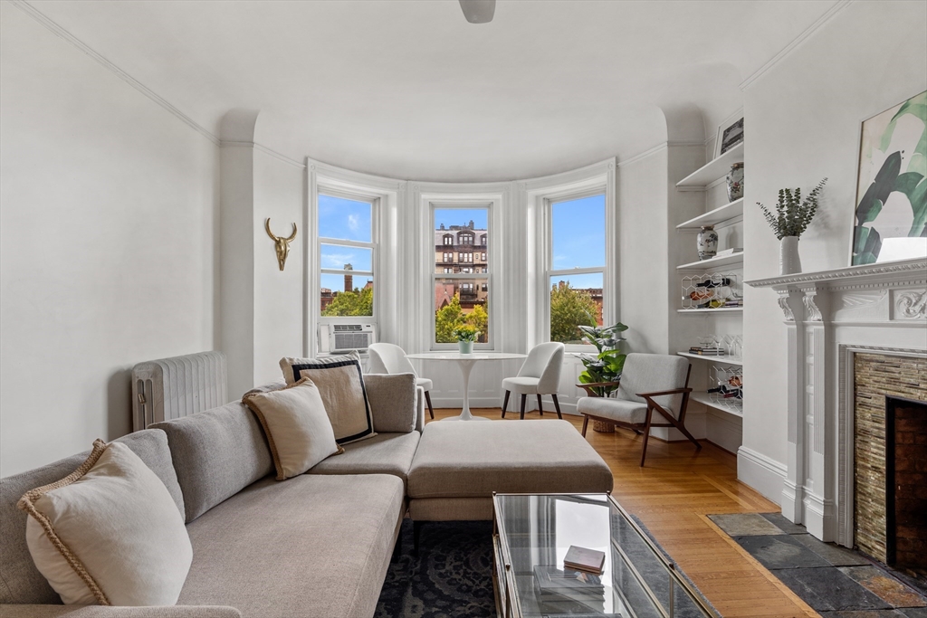 362 Commonwealth Avenue, Unit 4A Boston, MA 02115 - Photo 2 of 23 a living room with furniture fireplace and a large window