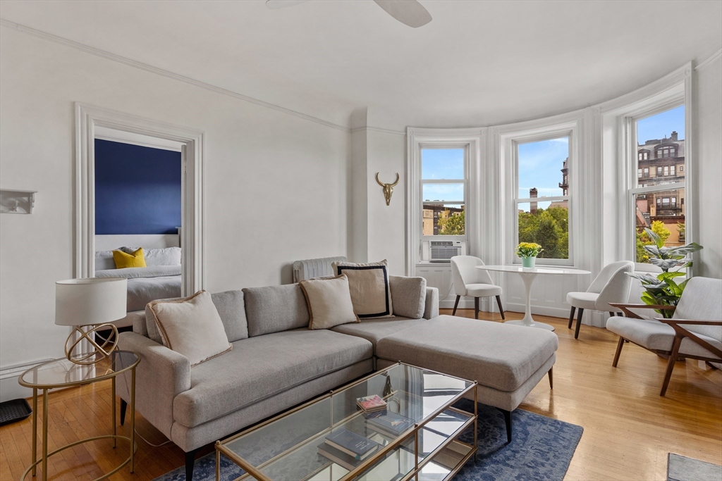 362 Commonwealth Avenue, Unit 4A Boston, MA 02115 - Photo 6 of 23 a living room with furniture and wooden floor