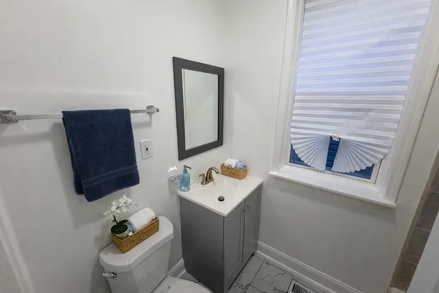 a bathroom with a sink toilet and mirror