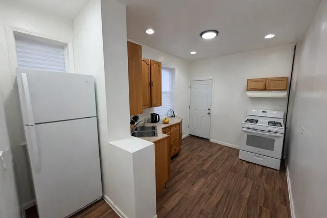 a kitchen with stainless steel appliances a refrigerator a sink and a stove top oven