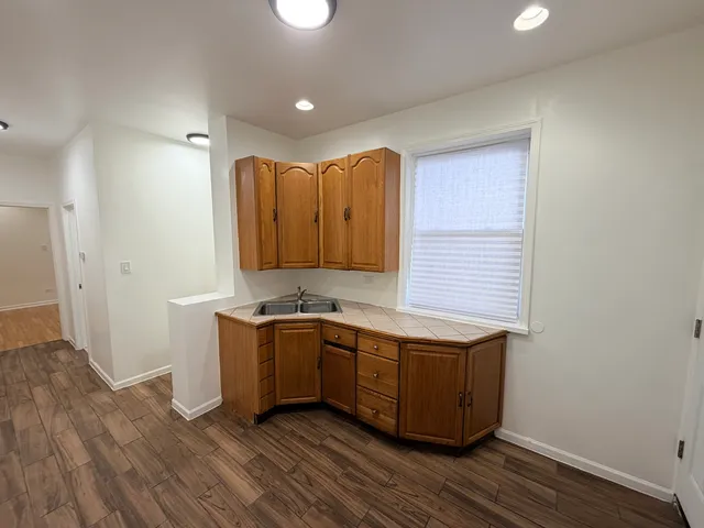 a kitchen with wooden cabinets and a sink
