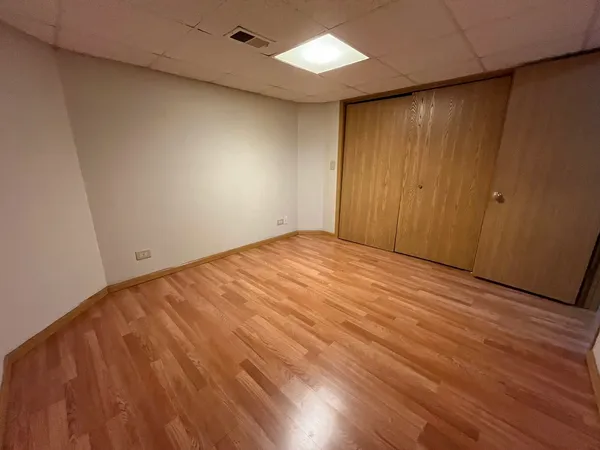 an empty room with wooden floor