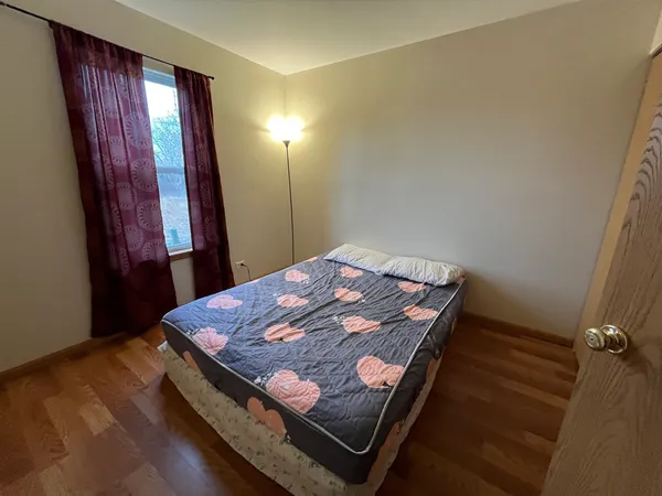 a bed sitting in a bedroom next to a window