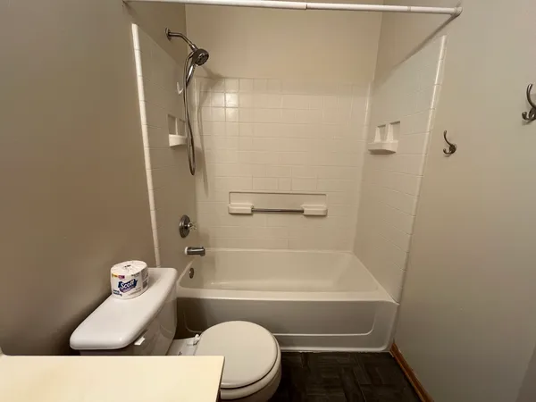 a bathroom with a sink and bathtub with toilet