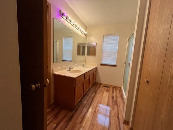 a bathroom with a double vanity sink and mirror