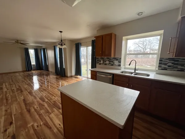 a kitchen with a sink a stove and cabinets