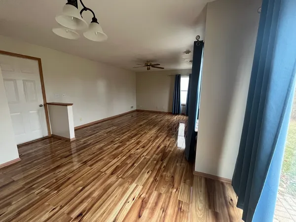 a view of a room with wooden floor and staircase