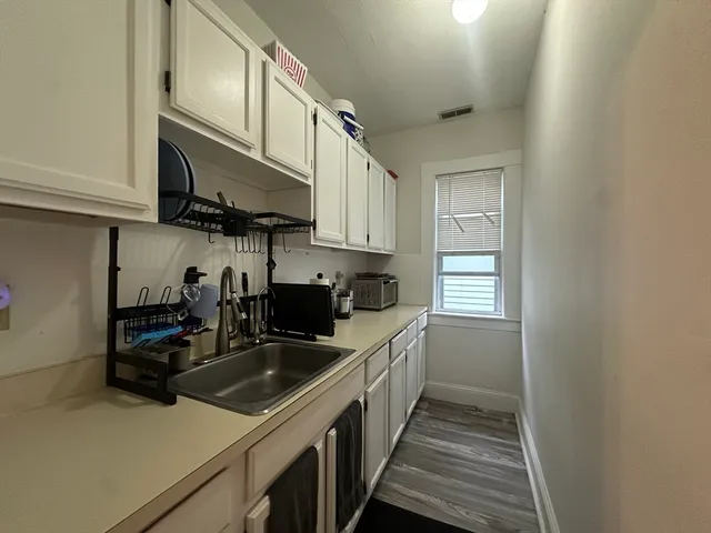 a kitchen with a sink a stove and cabinets