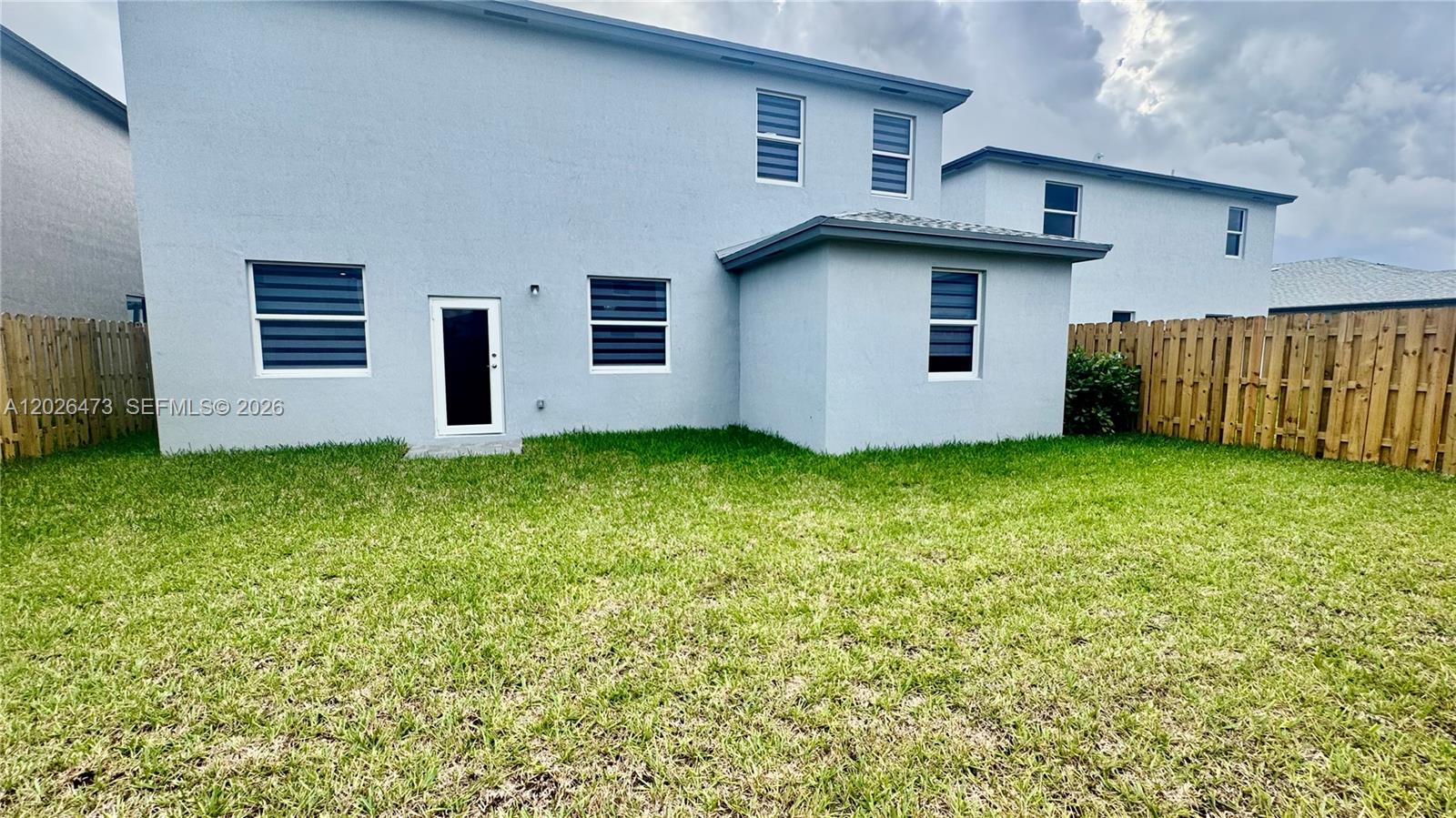19479 Southwest 340th Street, Unit 1 Homestead, FL 33034 - Photo 51 of 58 a view of front of house with a yard