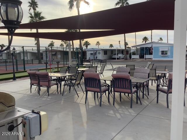 2605 South Tomahawk Road, Unit 10 Apache Junction, AZ 85119 - Photo 19 of 22 a view of a patio with a table and chairs