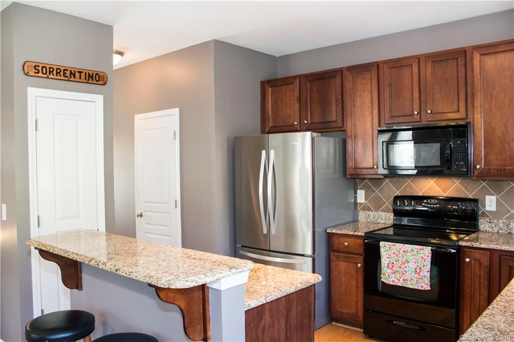 281 Sand Paver Way Fort Mill, SC 29708 - Photo 14 of 30 a kitchen with granite countertop cabinets and refrigerator