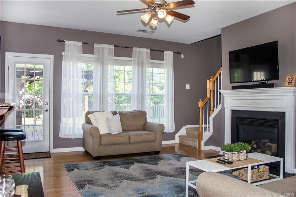 281 Sand Paver Way Fort Mill, SC 29708 - Photo 8 of 30 a living room with furniture a flat screen tv and a fireplace