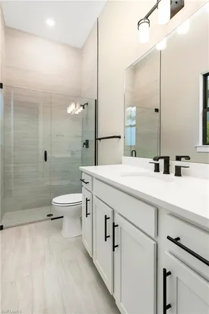 an empty room with window and a bathroom