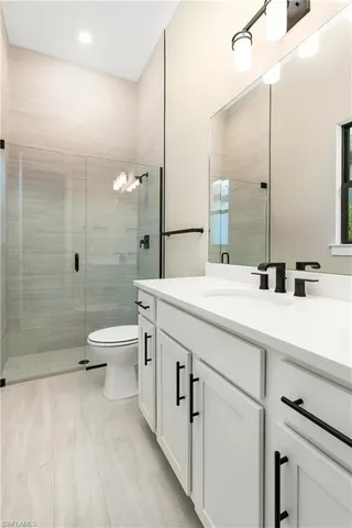 an empty room with window and a bathroom