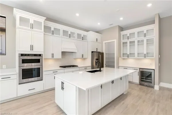 a kitchen with stainless steel appliances a stove top oven and a refrigerator