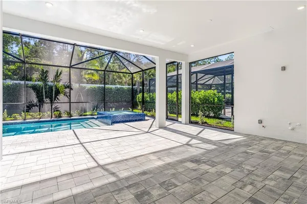 a view of a kitchen with refrigerator and wooden floor