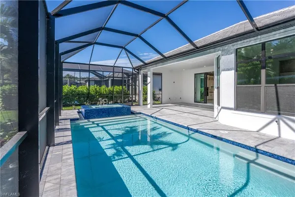 a view of a backyard with a swimming pool