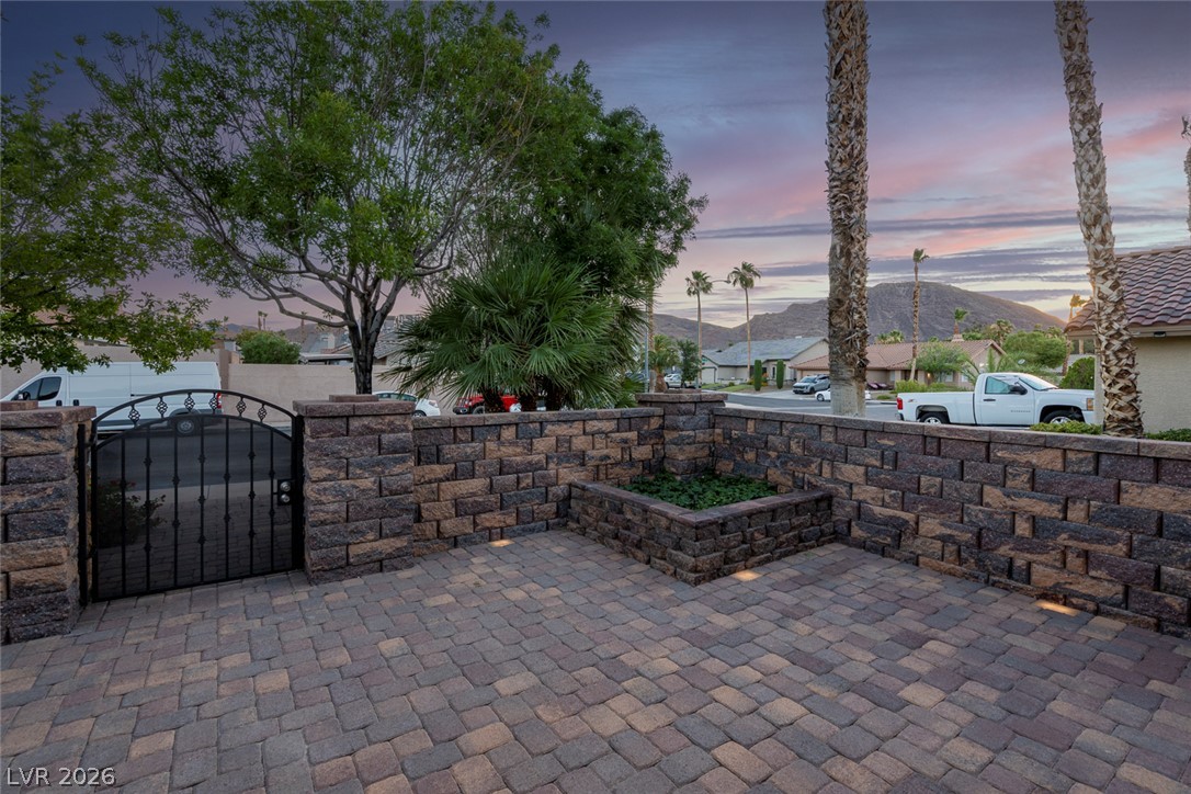 818 Manor Shores Road Henderson, NV 89002 - Photo 5 of 35 Secure, private courtyard entry framed by a stone block wall and wrought iron gate.